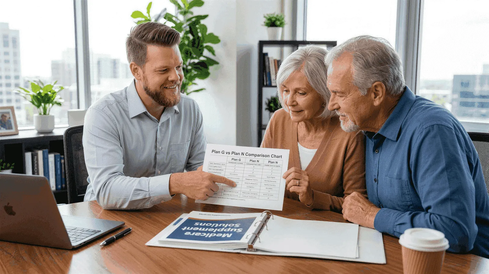 Big Sioux Benefits advisor Mike reviewing a Medicare Supplement Plan G and Plan N comparison document with a senior couple at a professional consultation desk
